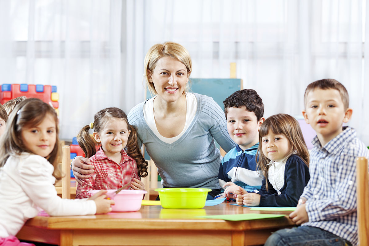 Teacher posing with smiling children