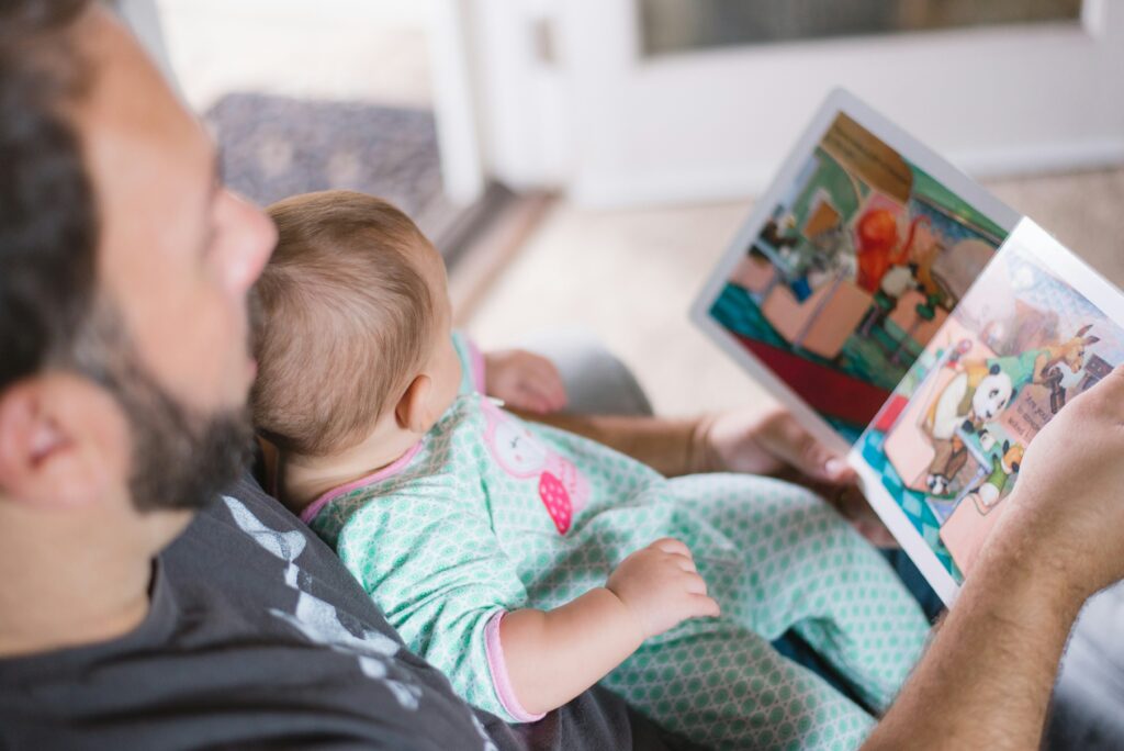 A parent having a good time with toddler as childcare applications for parents are open.