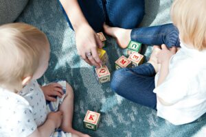 Early Years toddlers playing and learning with a practitioner at a Nursery in London
